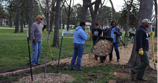 Students help clean up and mulch Stolley Park Gardens on Wednesday morning 